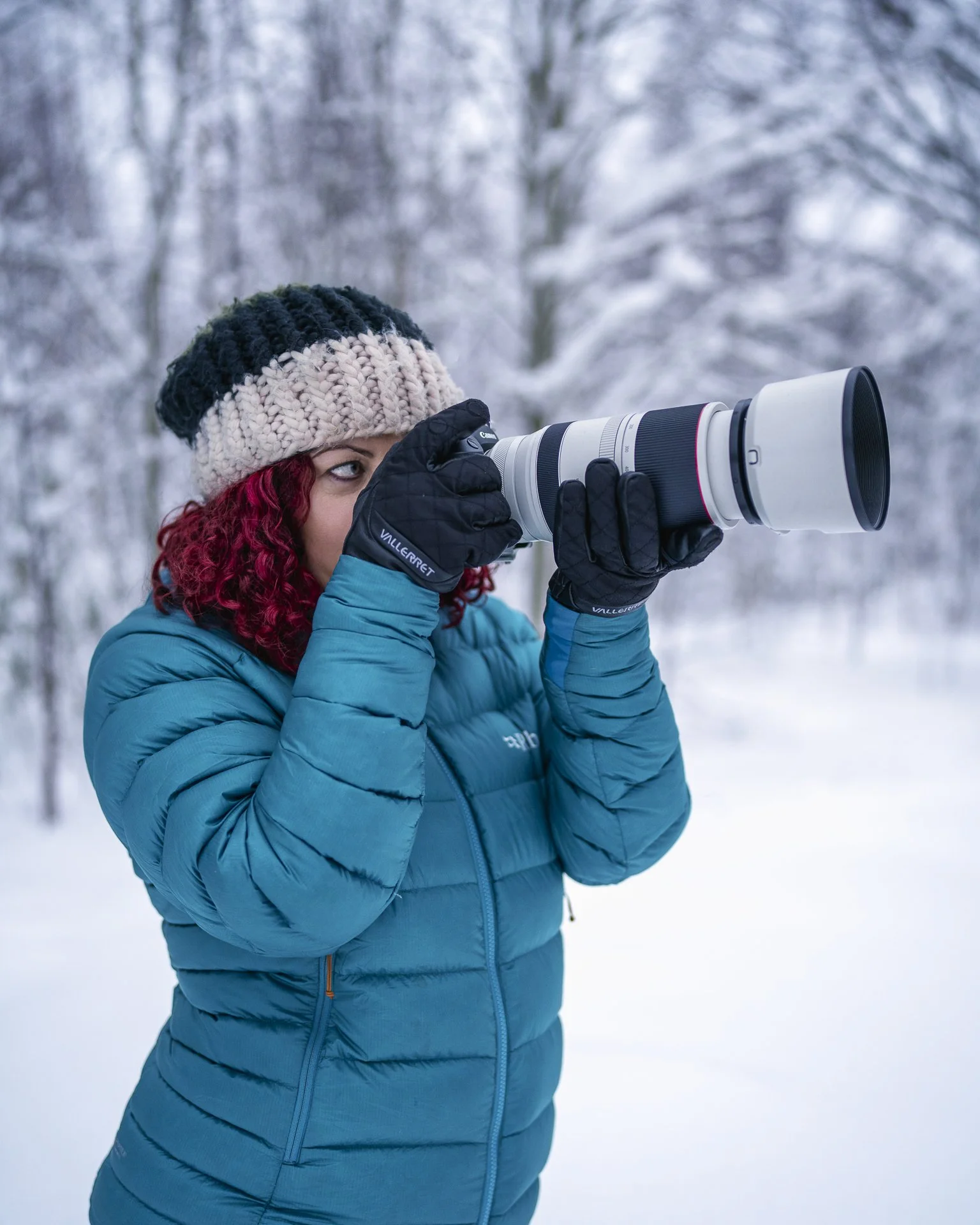 Wildlife photographer Rhiannon Lawler working in the snow with her camera