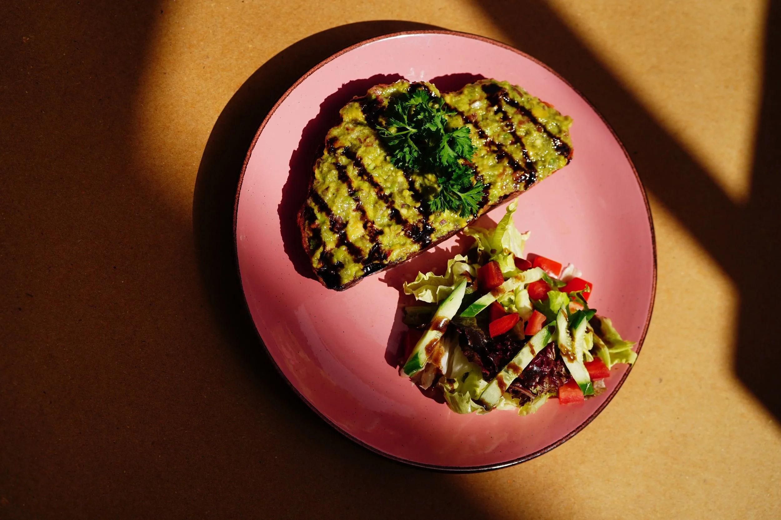 A brunch favorite – creamy avocado toast meets crisp garden salad.