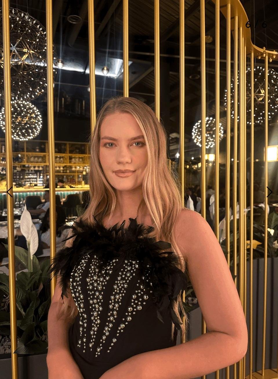 Woman wearing the Bella dress in a fancy resturant.jpg