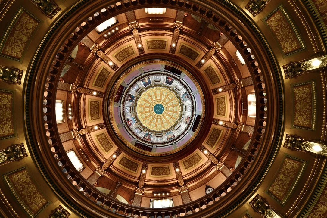 Close-up of painted artwork inside the Capitol dome featuring classical figures and decorative motifs