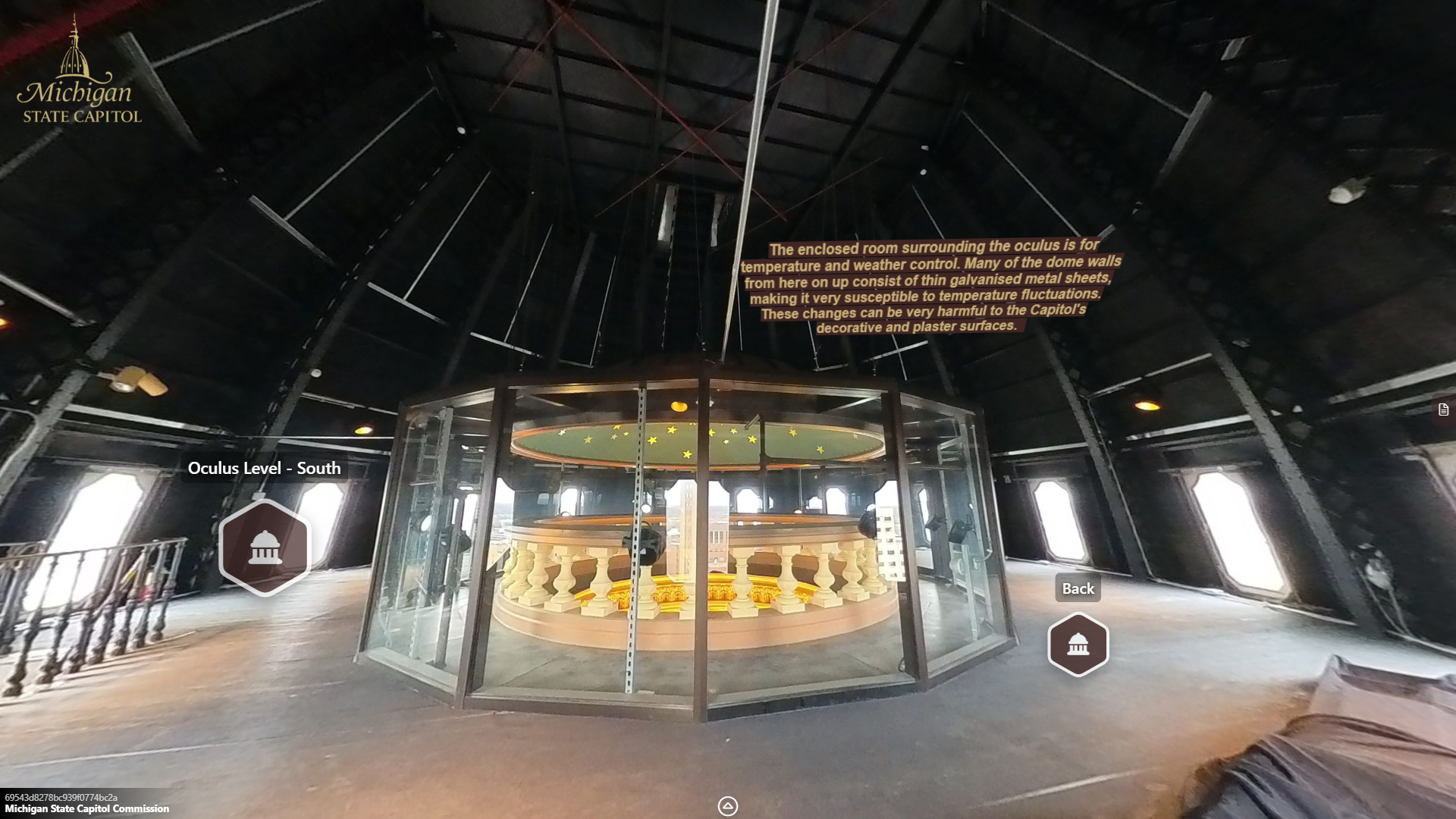 image of a large open space with windows inside of the dome with large black metal trusses extending upwards, a staircase rising int he middle of the space toward the ceiling, and a glass enclosure encircling the oculus railing.