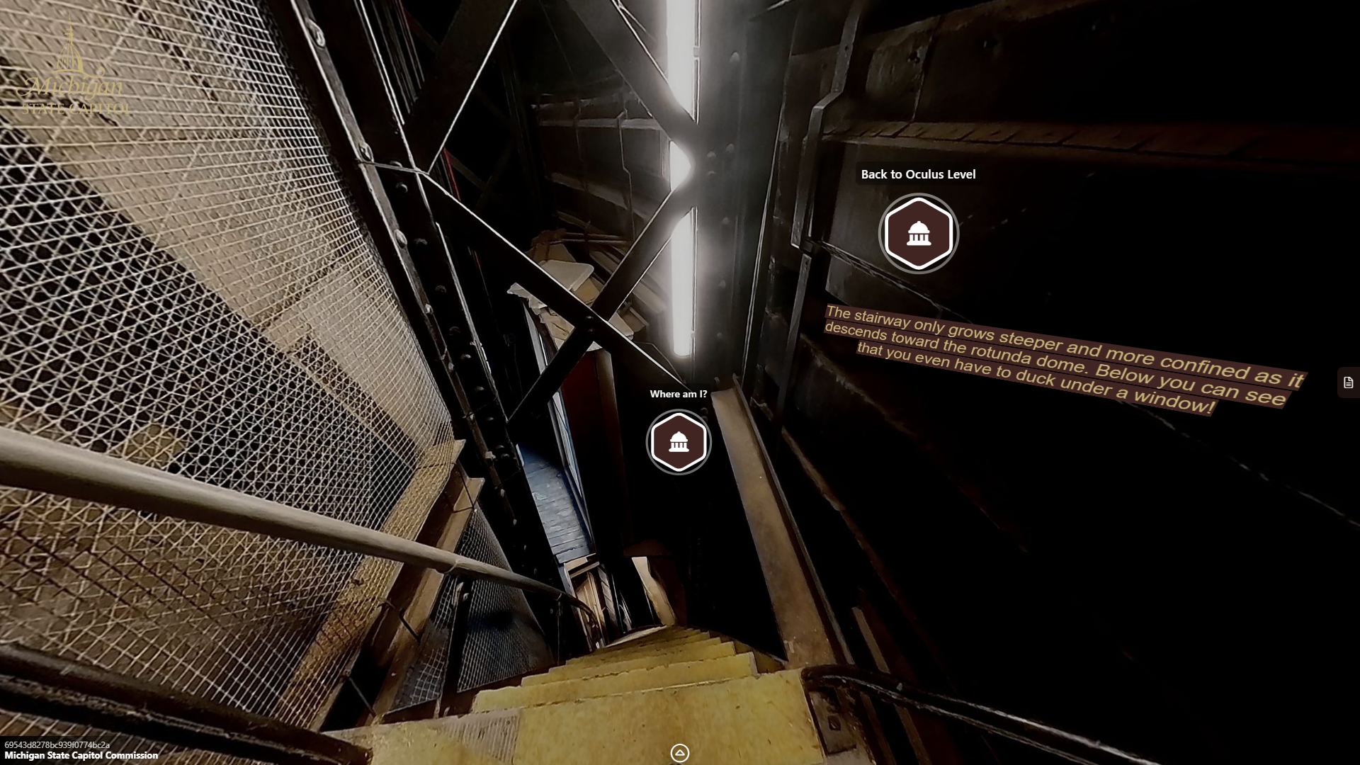 image of a very narrow stairway steeply leading downward between metal walls and columns.