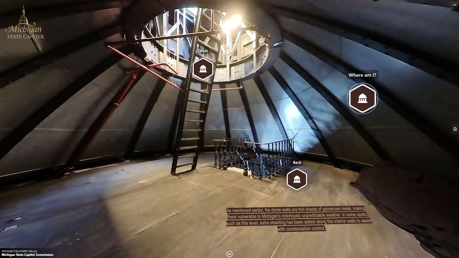 a circular room with metal walls that bend inward toward the top, where a metal circular opening with a staircase leads upward. Below a metal staircase with railing leads downward.