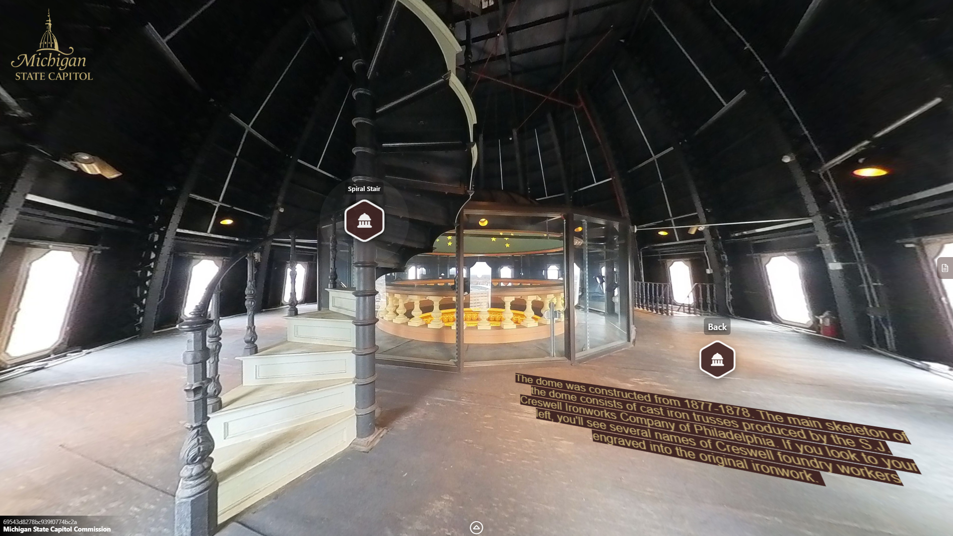 image of a large open space surrounding a circular glass enclosure around the oculus, with a metal spiral staircase leading upwards.