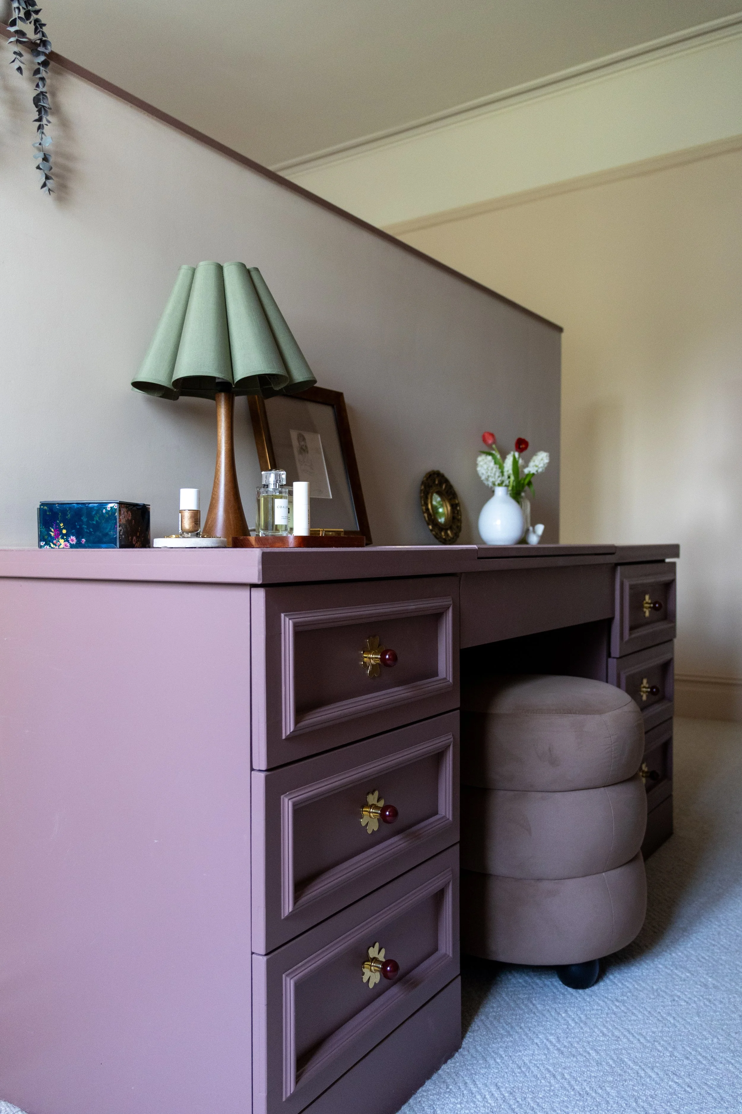Painted dressing table with brass drawer knobs and green pleated table lamp, styled by Nest Interior Design Manchester