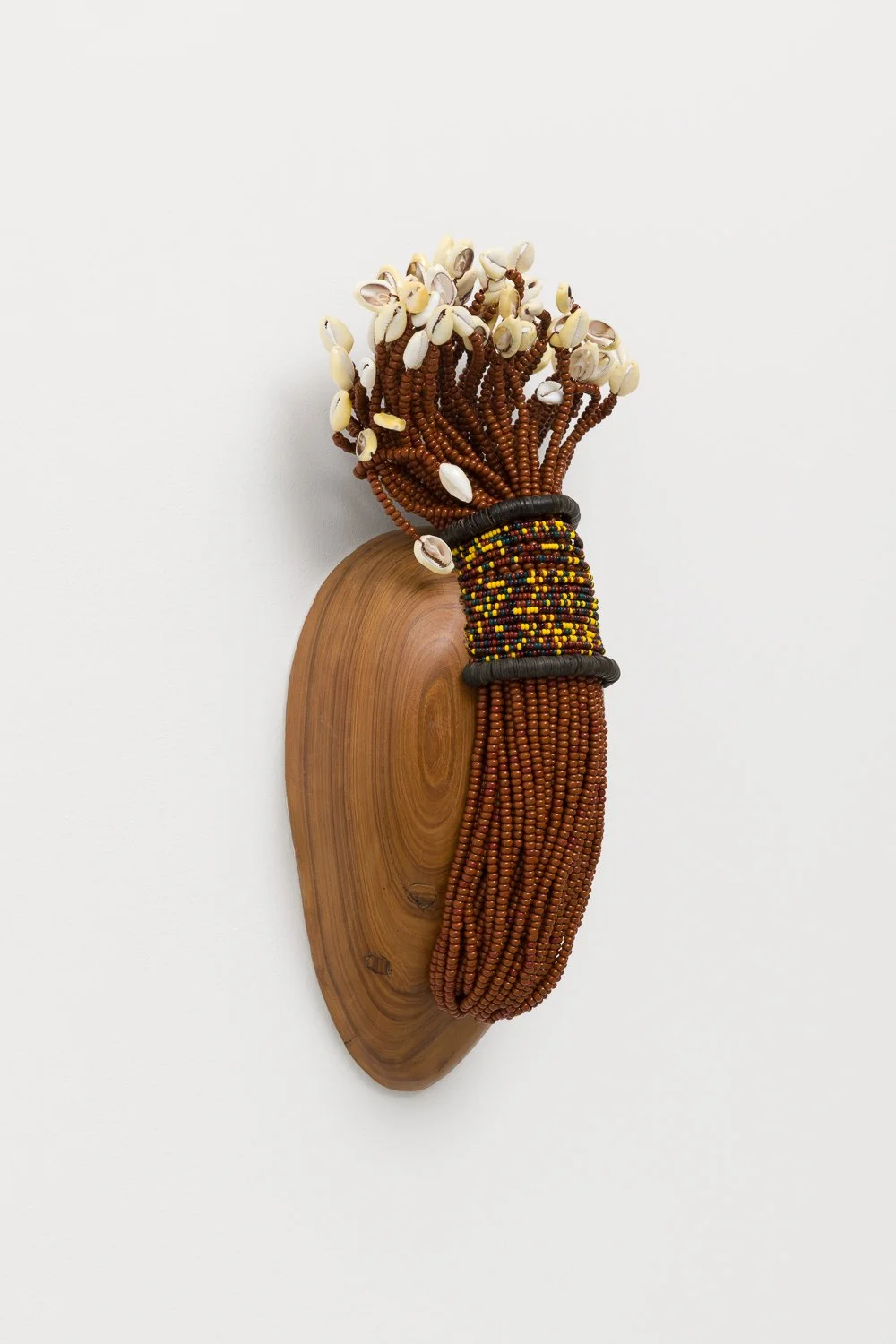 Nádia Taquary, Oriki 2413, 2024, Reclaimed wood, lagdibás, cowry shells, glass beads and copper
