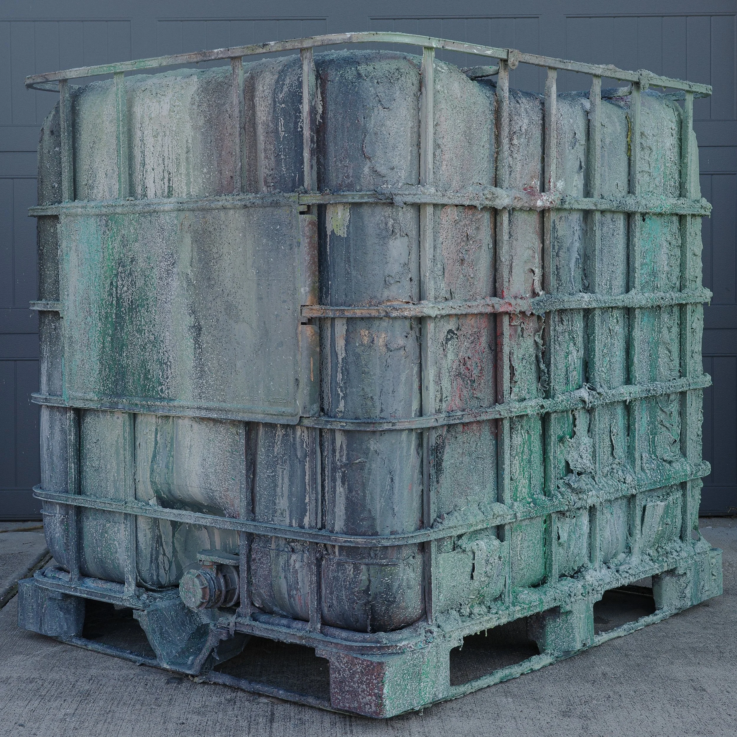 Jaylon Hicks;
Naphtha Tote, 2025;
Sand, acrylic and house paint on industrial tote;
121.2 x 101 x 114.6 cm;
47 3/4 x 39 3/4 x 45 1/8 in.