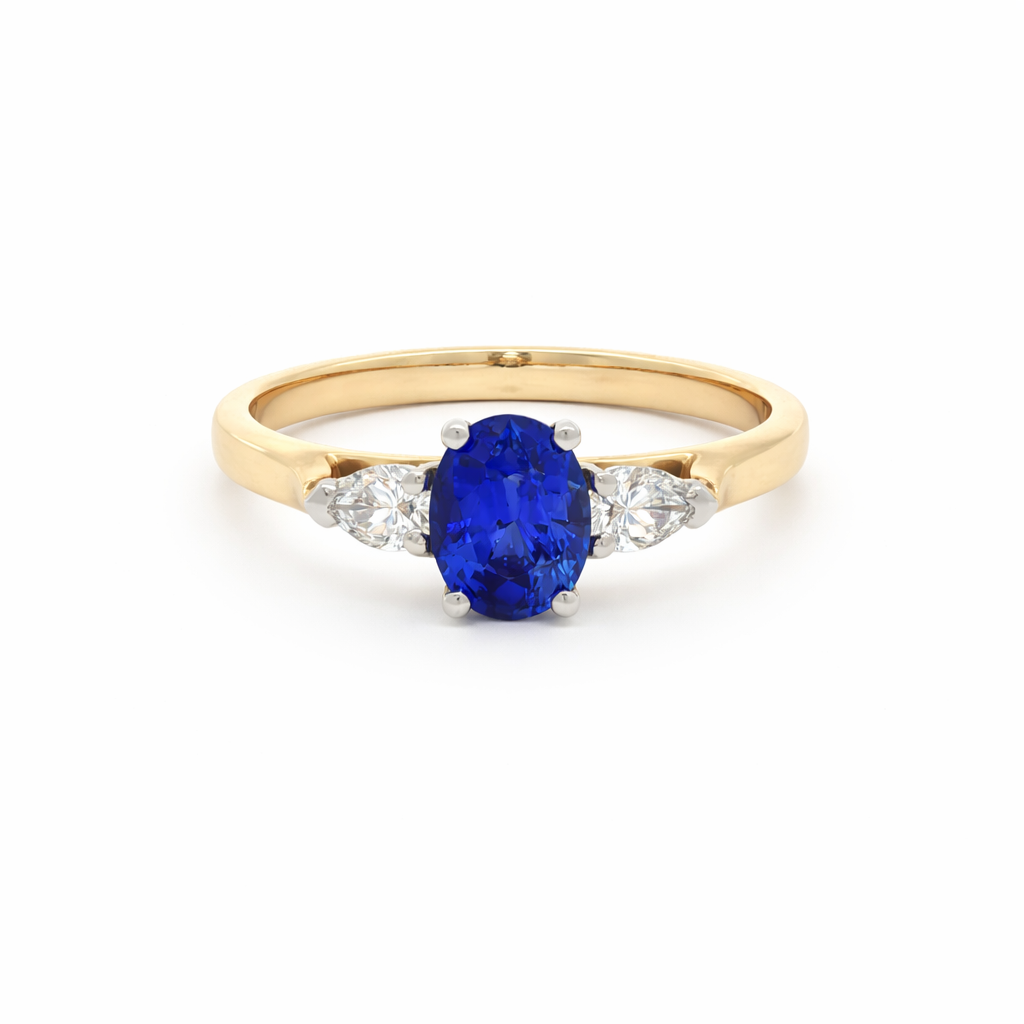 Gold ring with blue oval gemstone and two small clear stones on each side, set against a white background.