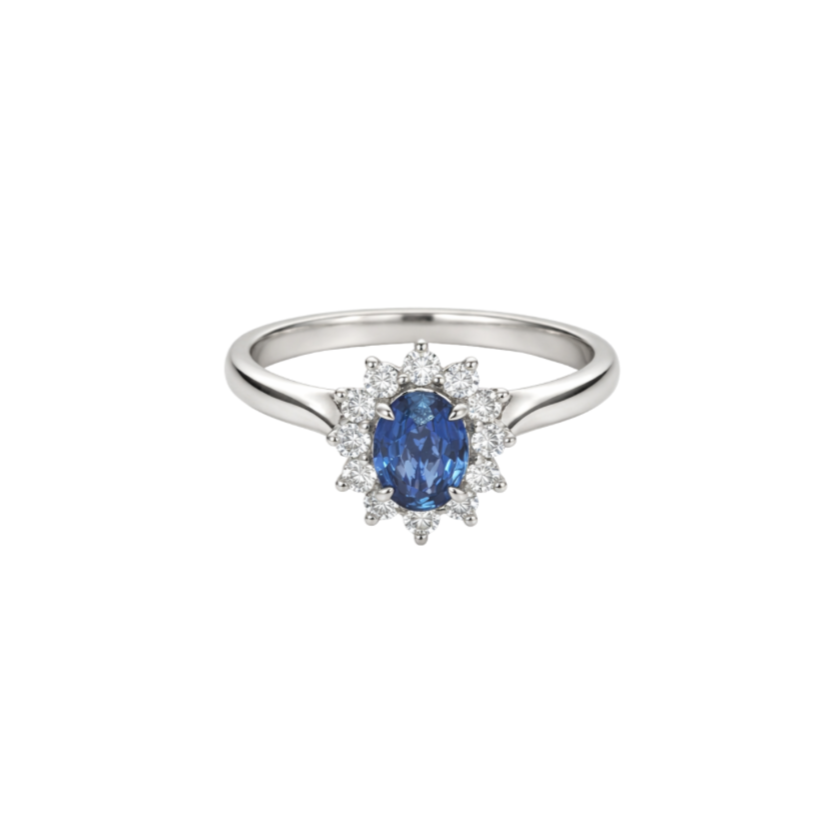 A silver ring with an oval blue gemstone surrounded by small clear diamonds.