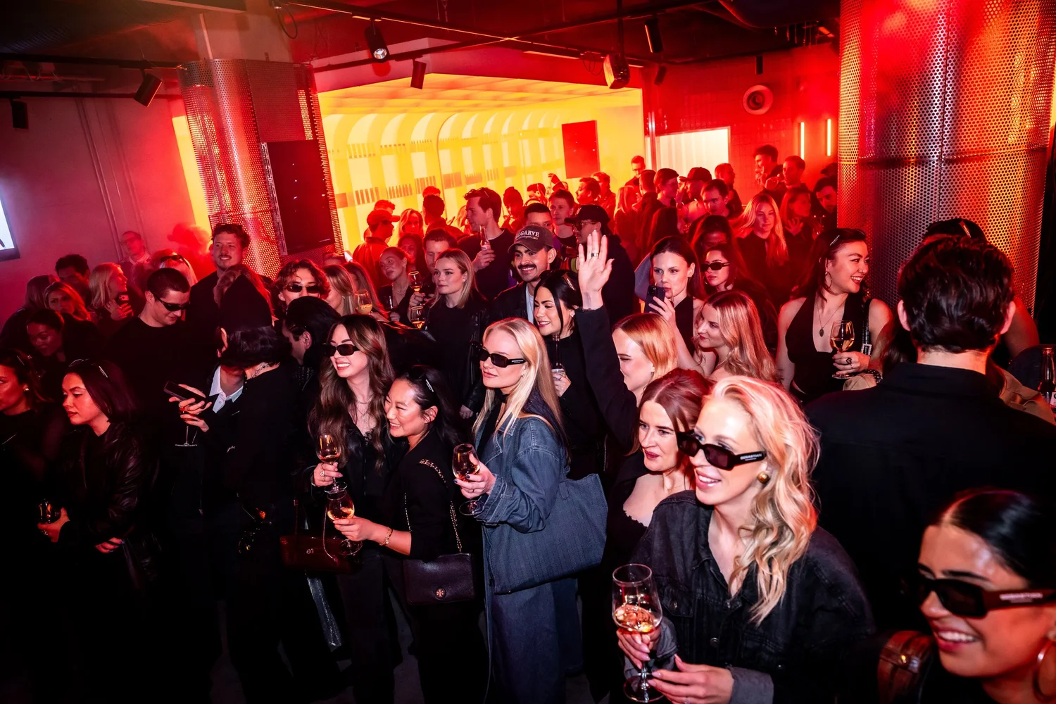 Crowd of guests in sunglasses at the event