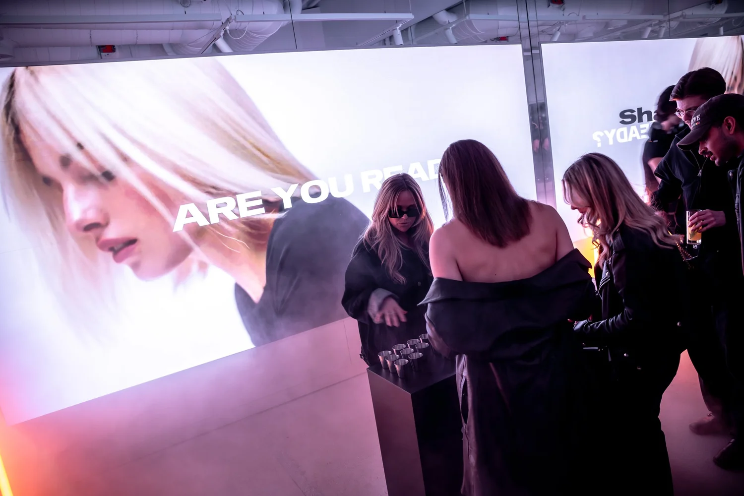Guests in front of the screen with hair campaign film