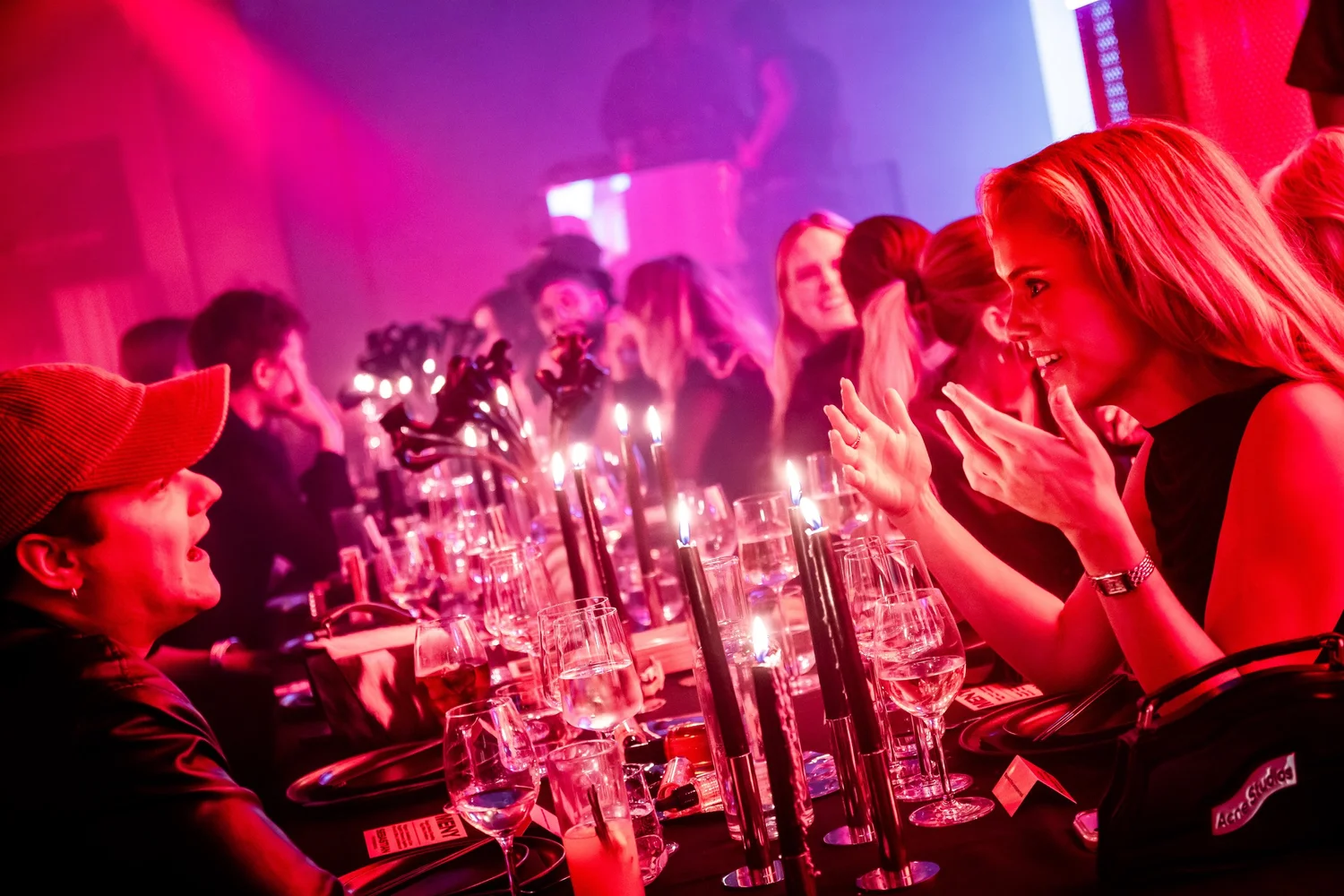 Guests talking at the candlelit table