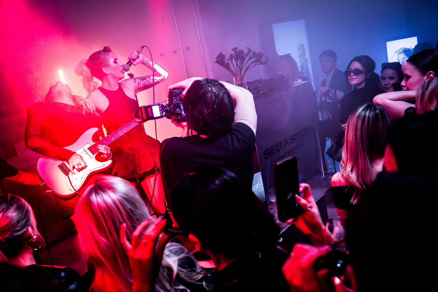 Live band performing for guests in red light