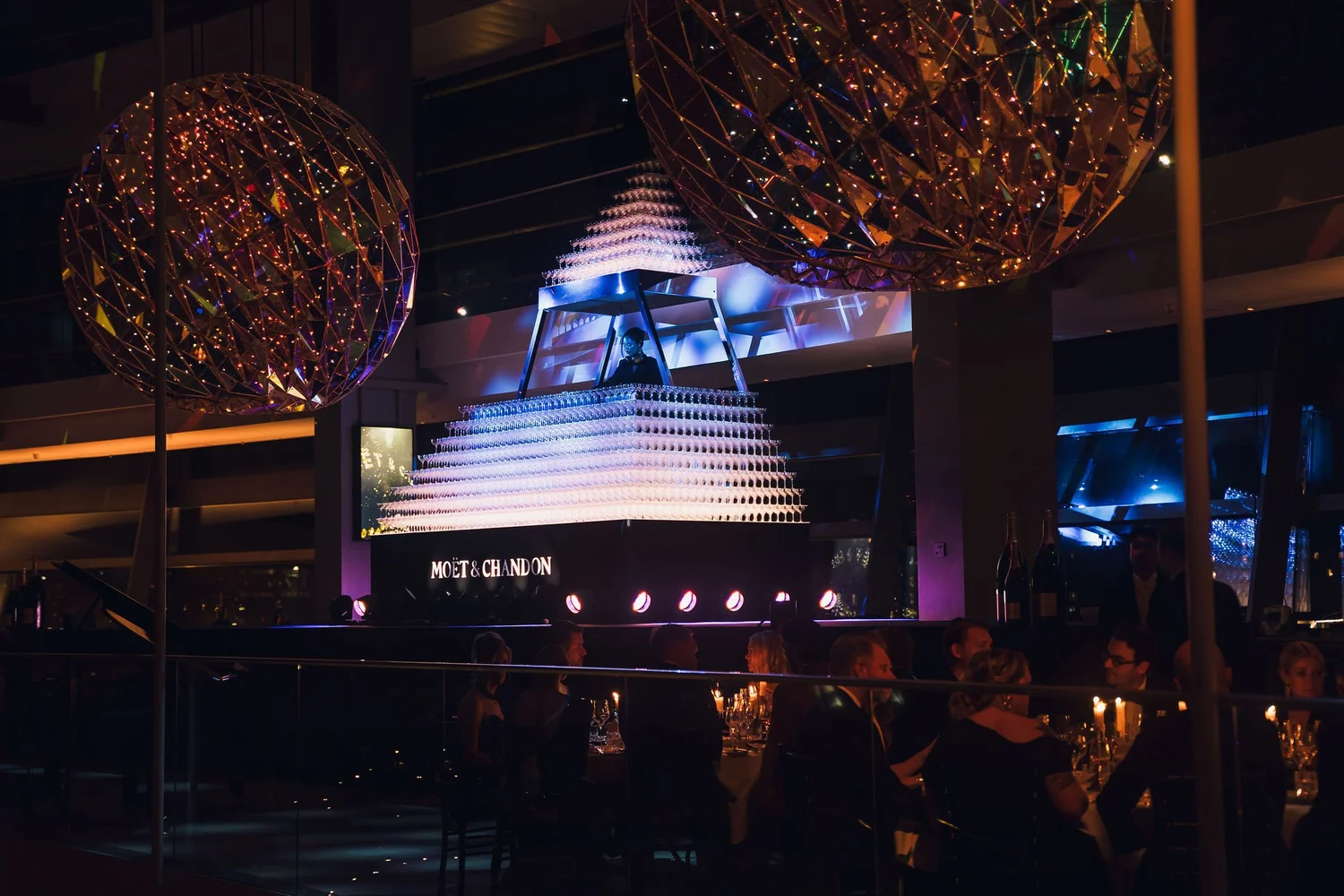 The illuminated champagne-glass pyramid stage during the evening event