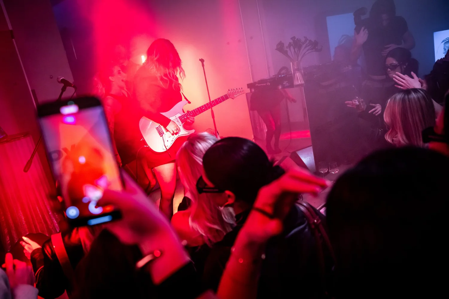 Guest filming the live performance on a phone
