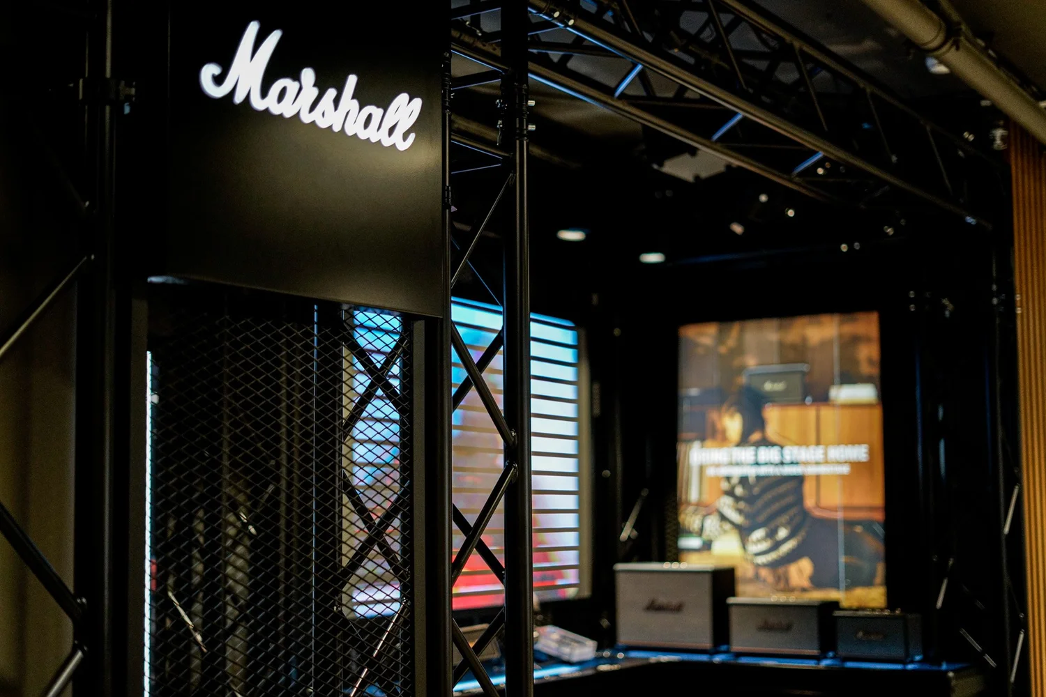 Marshall shop-in-shop with black truss frame and illuminated logo at Elgiganten, Kungsgatan