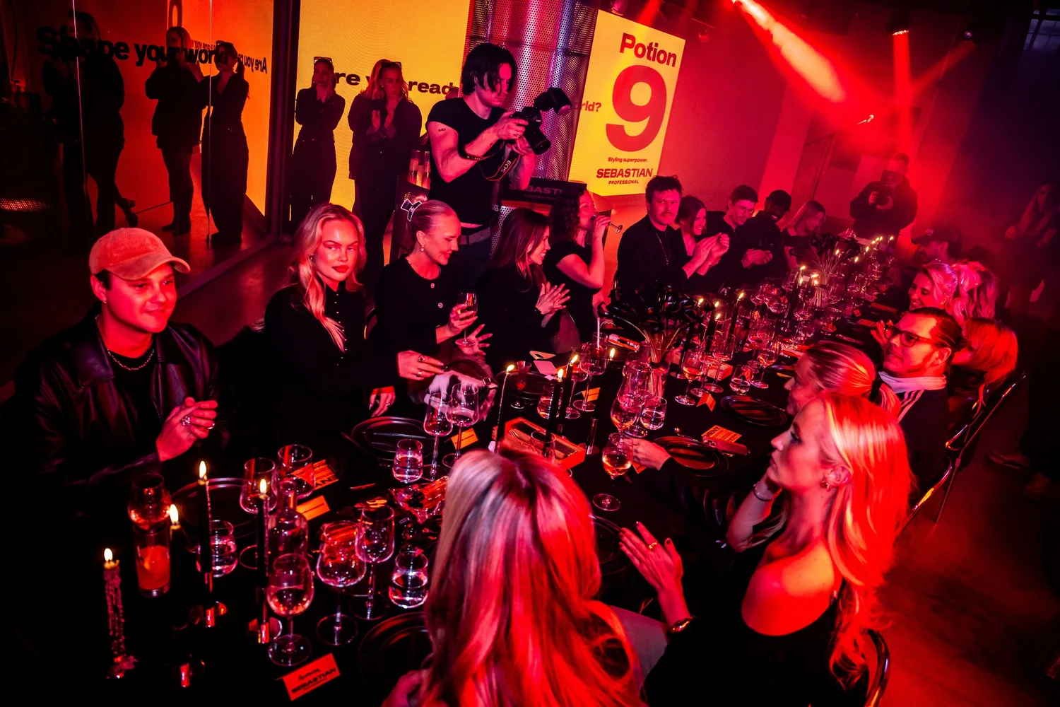 Guests at the dinner with Potion 9 branding in the background