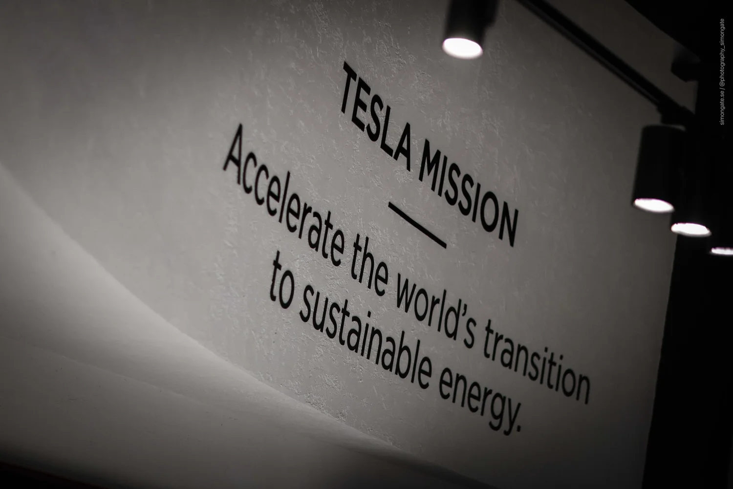 Tesla Mission statement on the store wall: accelerate the world’s transition to sustainable energy