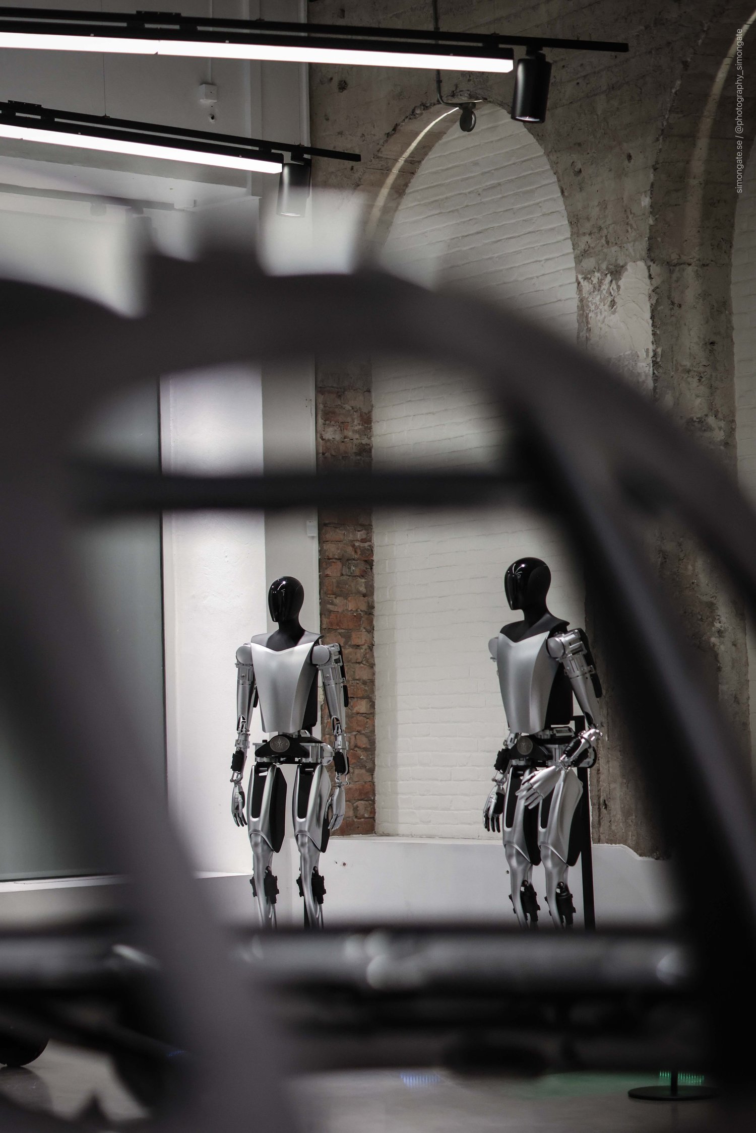 Two Tesla Optimus robots on display in the flagship store