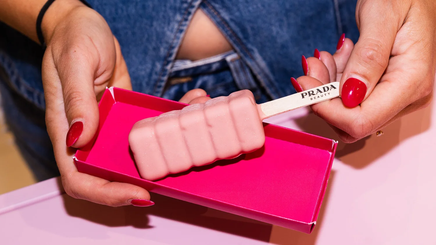 Pink ice cream on a Prada Beauty stick in a magenta tray