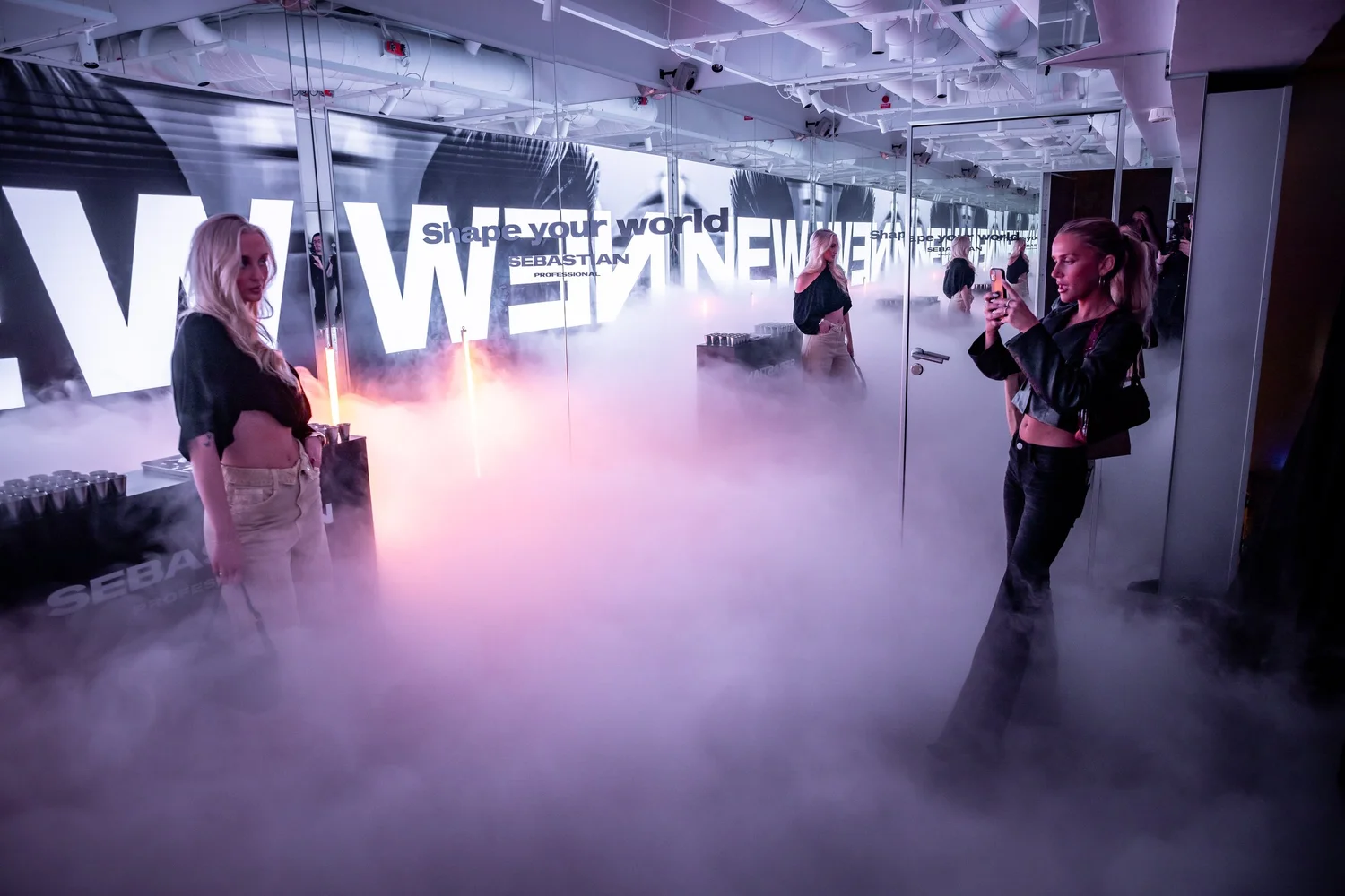 Guest walking through fog in front of the NEW WAVE installation