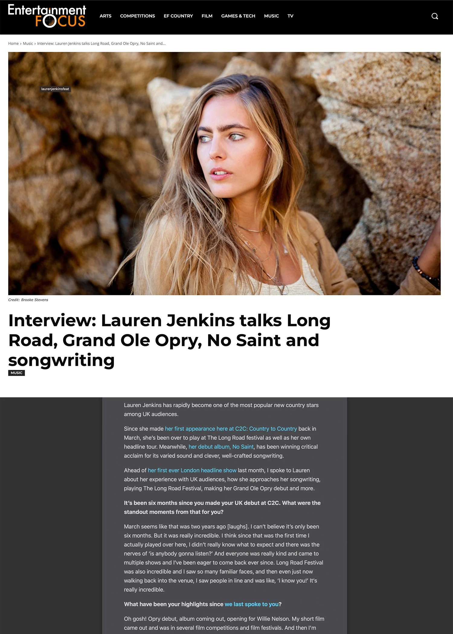 Portrait of Lauren Jenkins with long wavy blonde hair, gazing to her left, set against a background of large, textured rocks.