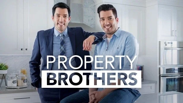 Two men posing in a modern kitchen with the text 'Property Brothers' overlaid.
