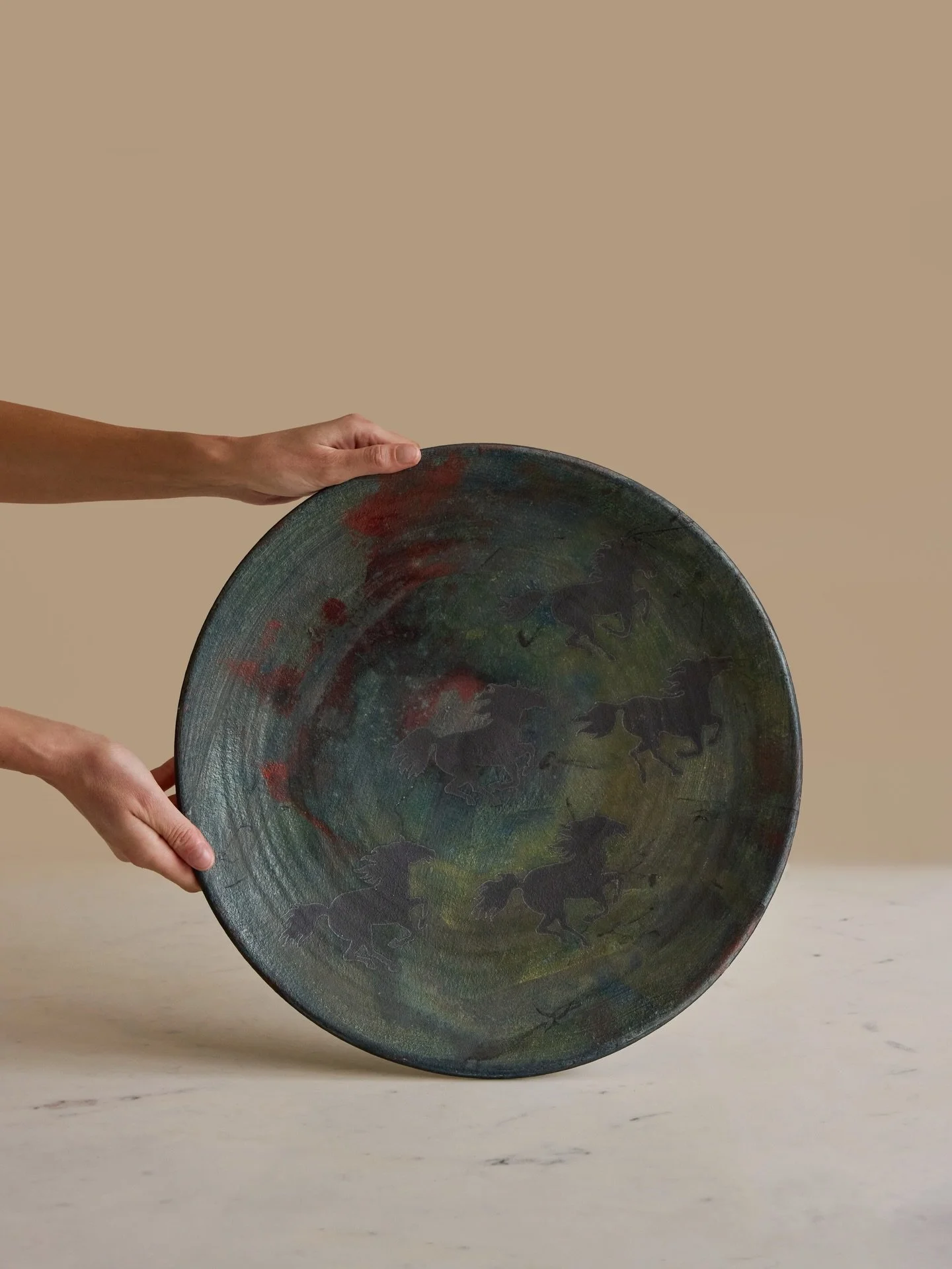 Available | The perfect nod to the year of the horse, a fantastically large signed horse raku pottery bowl. 

A striking and imposing one-off piece, the bowl is artist-made and beautifully depicts five horses in its centre. 

Available online now! 

