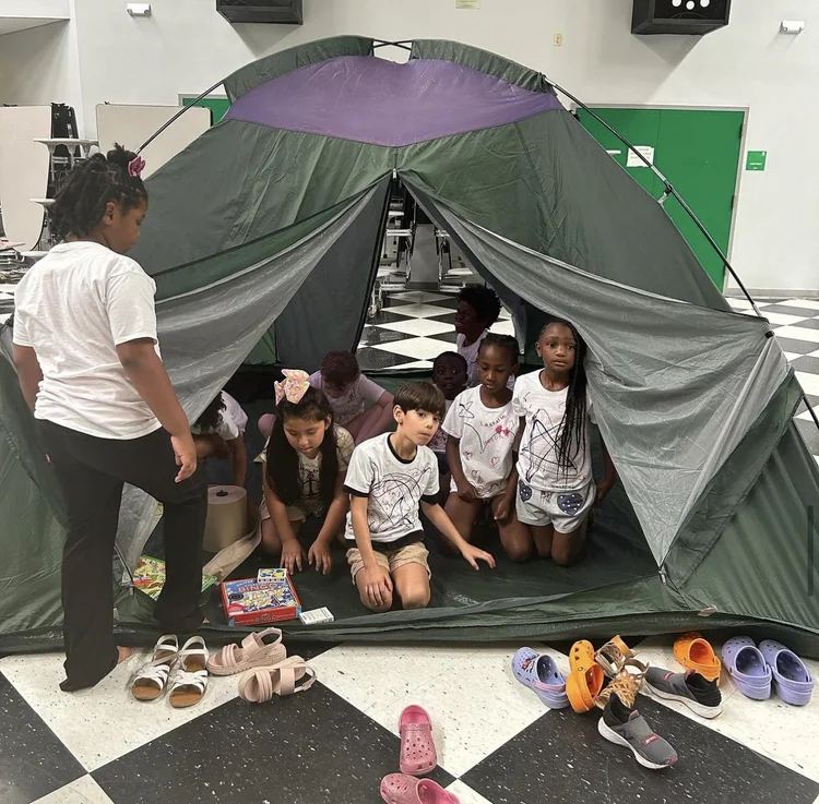 Children inside a tent at an indoor family night
