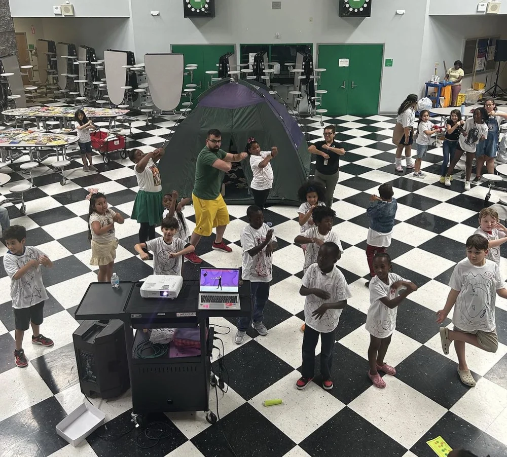 Families dancing at an AIMS family night