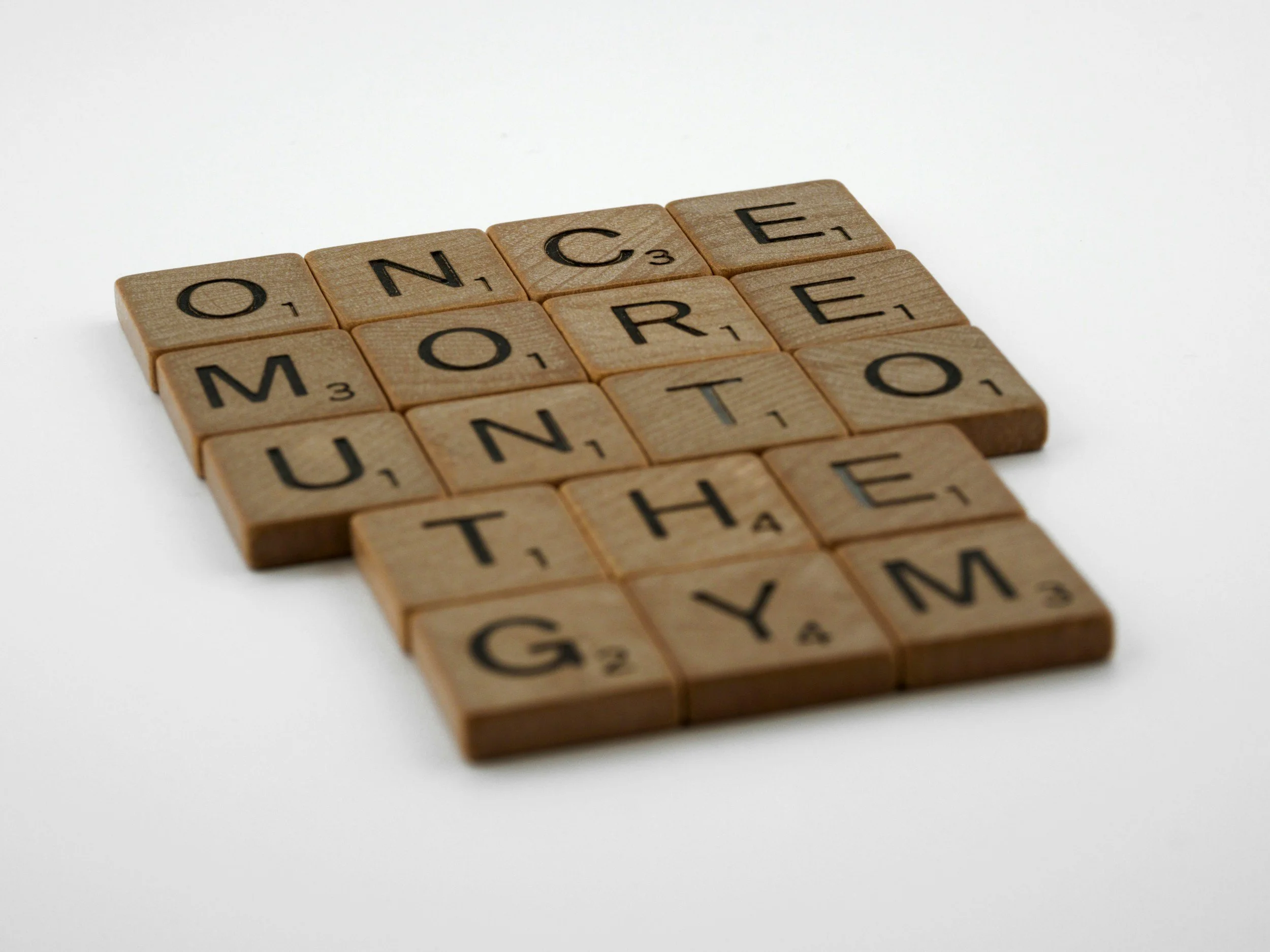 Scrabble tiles spelling out 'ONCE MORE UNITE THE MARY' on a white background.