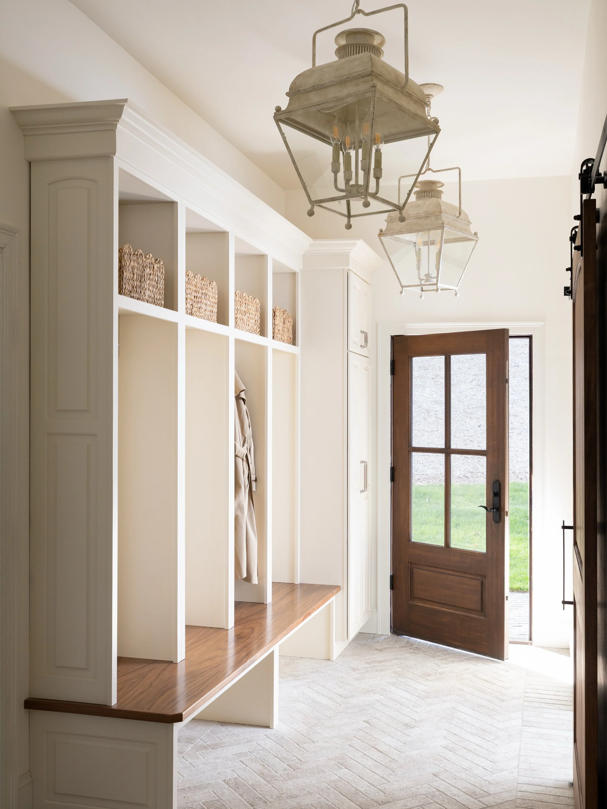 Custom millwork, chevron brick and vintage lanterns making all the difference 🤍