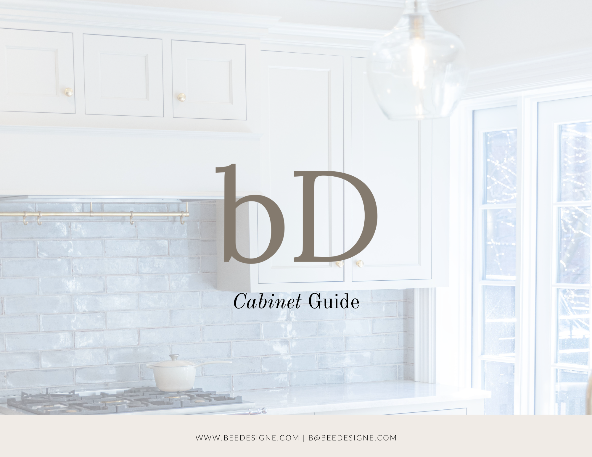 White kitchen cabinets with gold knobs, a window with white trim, a white countertop, a coffee pot, and a cookbook on the countertop. The image is overlaid with the text '1b Cabinet Guide' and the website URL 'WWW.BEEDESIGNE.COM | B@BEEDESIGNE.COM'.