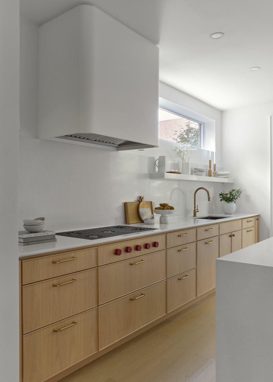 Custom White Oak Cabinetry and integrated wolf gas cooktop