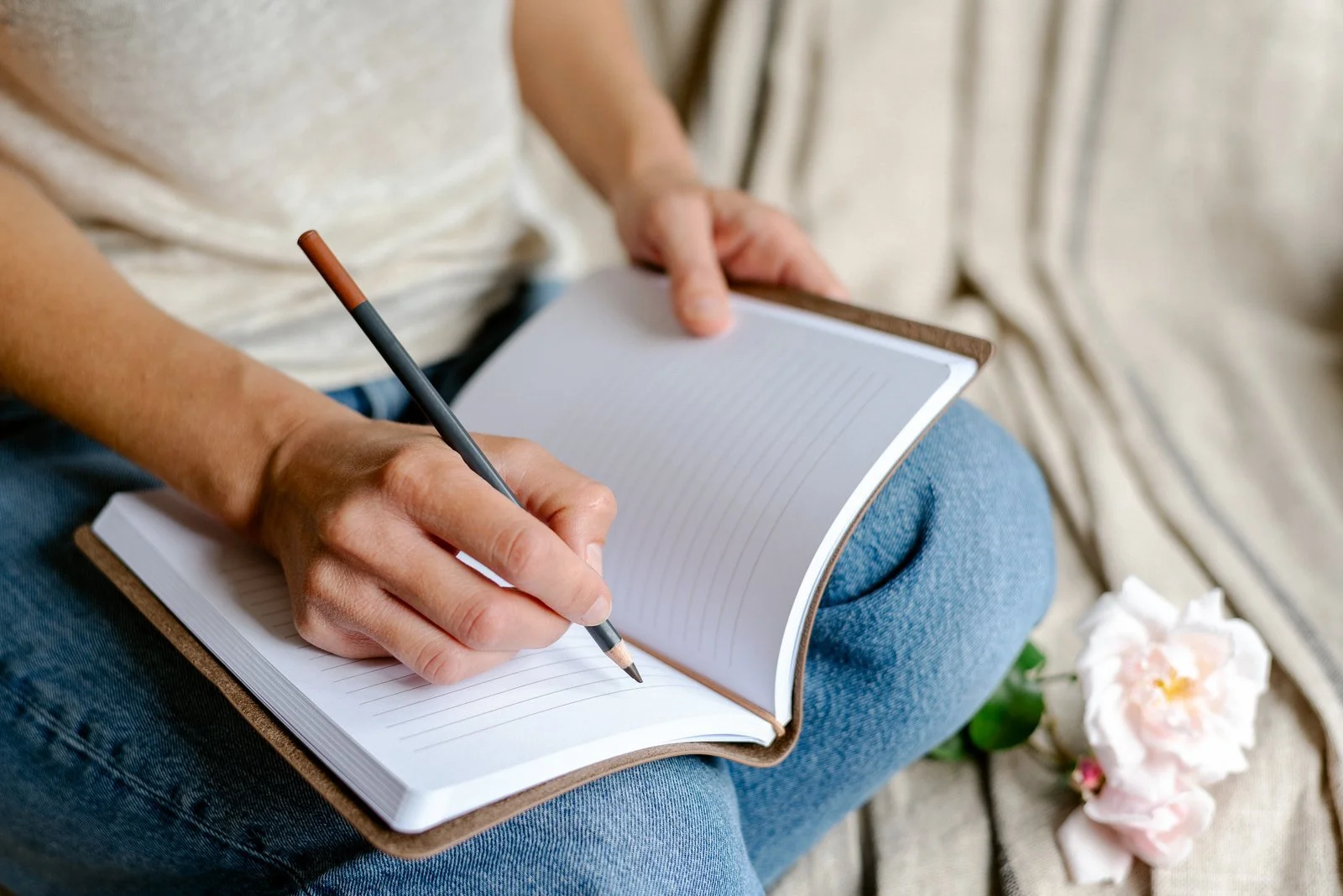 Woman writing in a journal at home