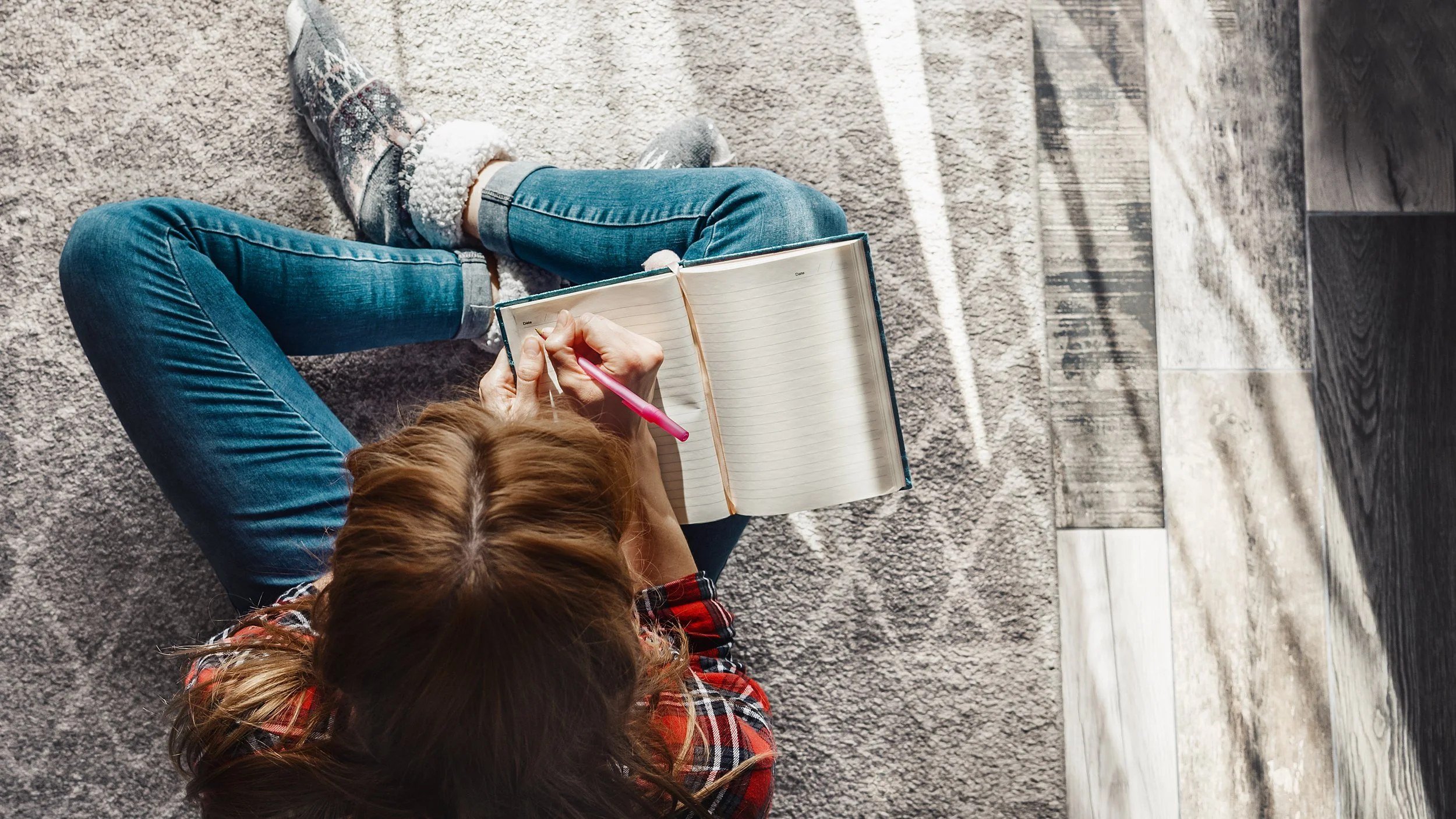 Woman journaling on a cozy blanket