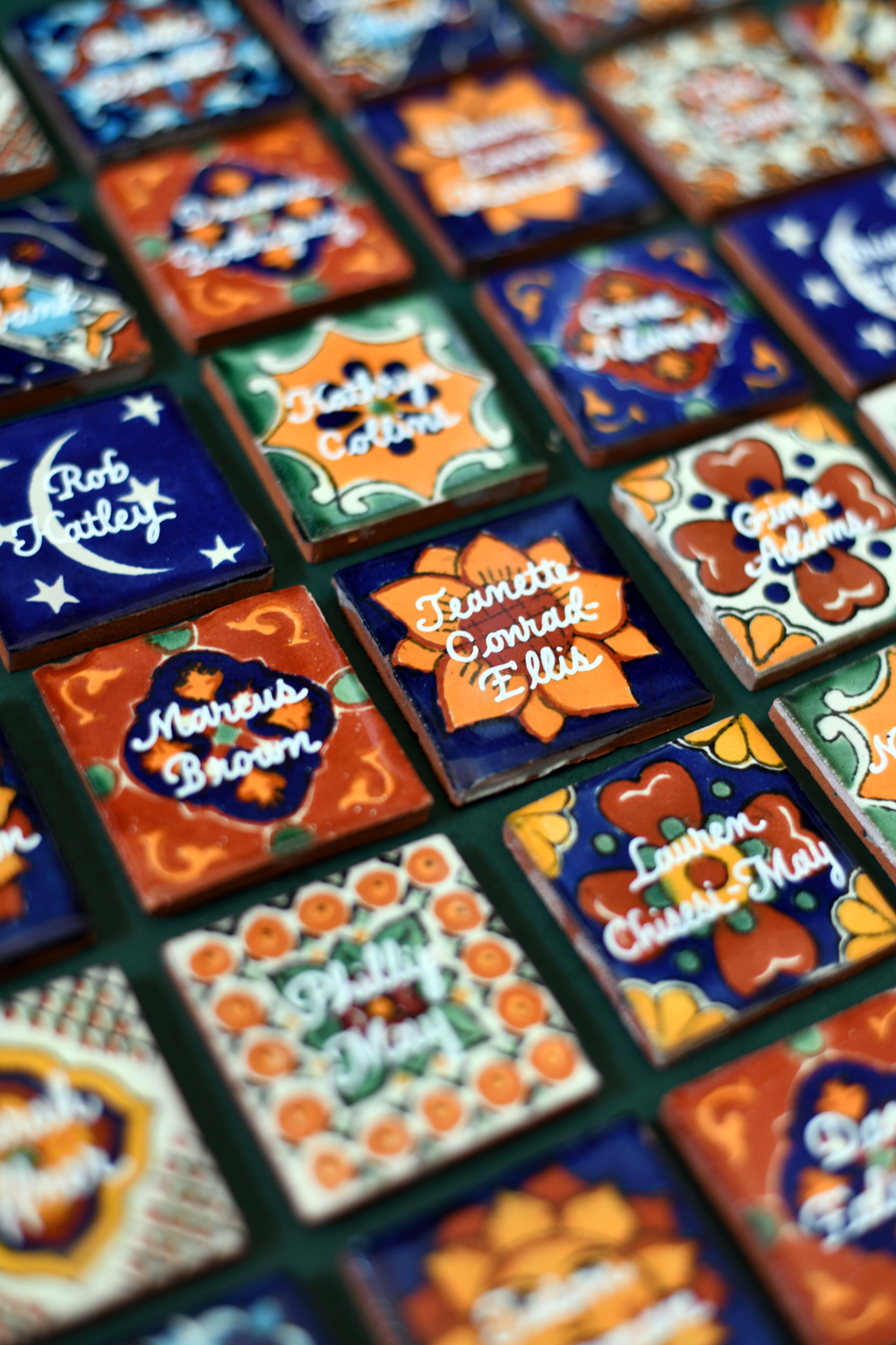Custom Mexican Azulejo tile place cards with gold hand-lettered calligraphy for a luxury Austin event
