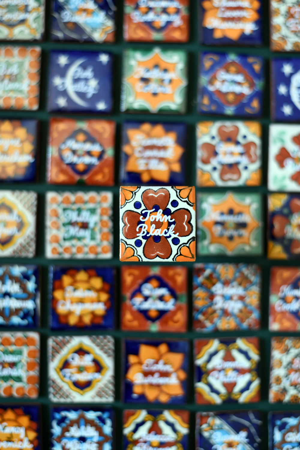 Custom Mexican Azulejo tile place cards with gold hand-lettered calligraphy for a luxury San Antonio event