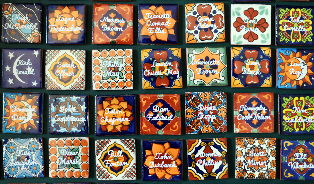 Custom Mexican Azulejo tile place cards with gold hand-lettered calligraphy for a luxury San Antonio event