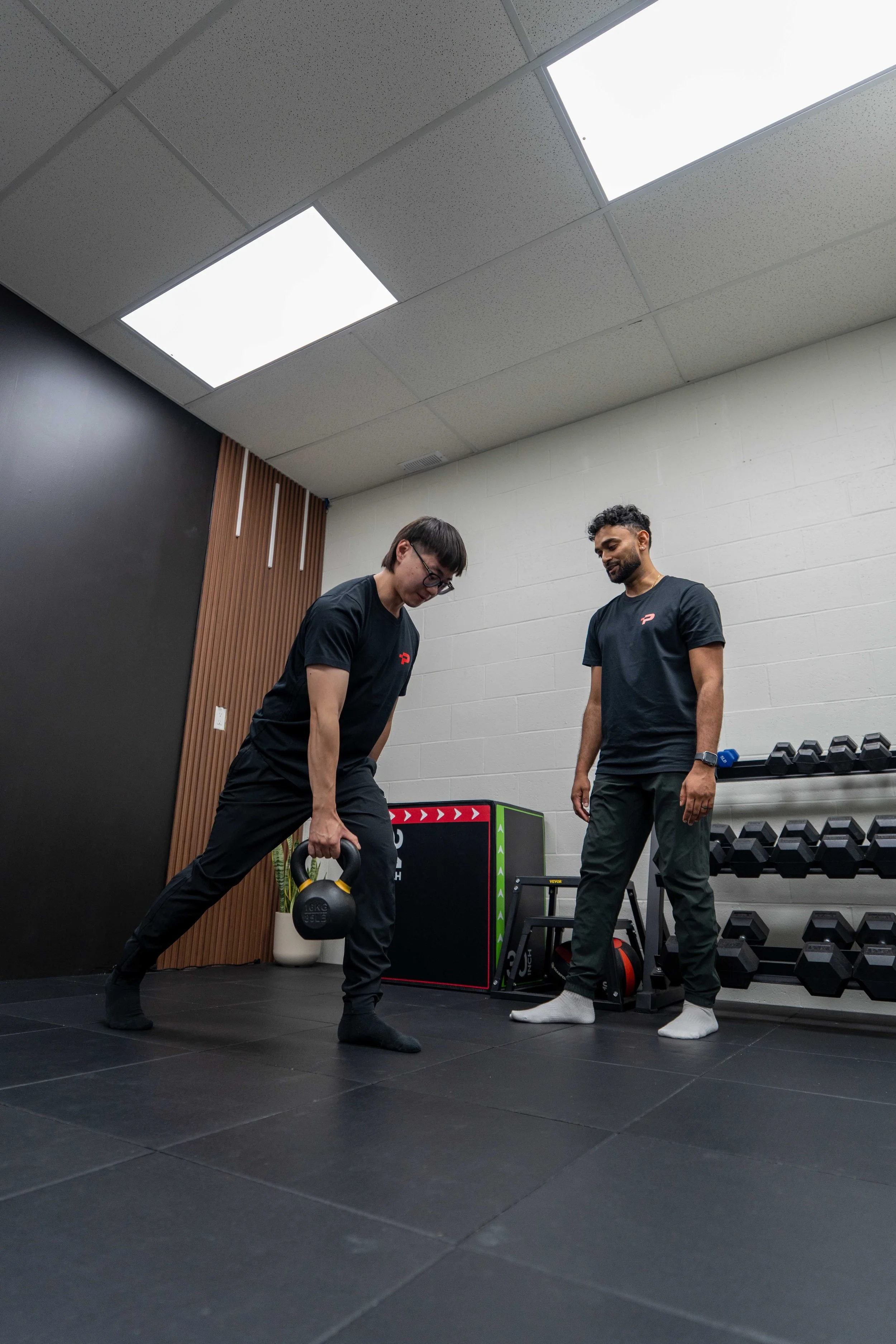 Physiotherapist coaching corrective exercise at Plus Ultra Performance & Therapy