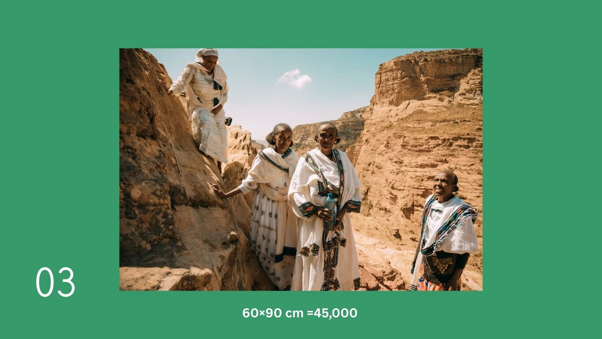 Group of five elderly women in traditional clothing exploring rocky desert landscape with cliffs in the background.