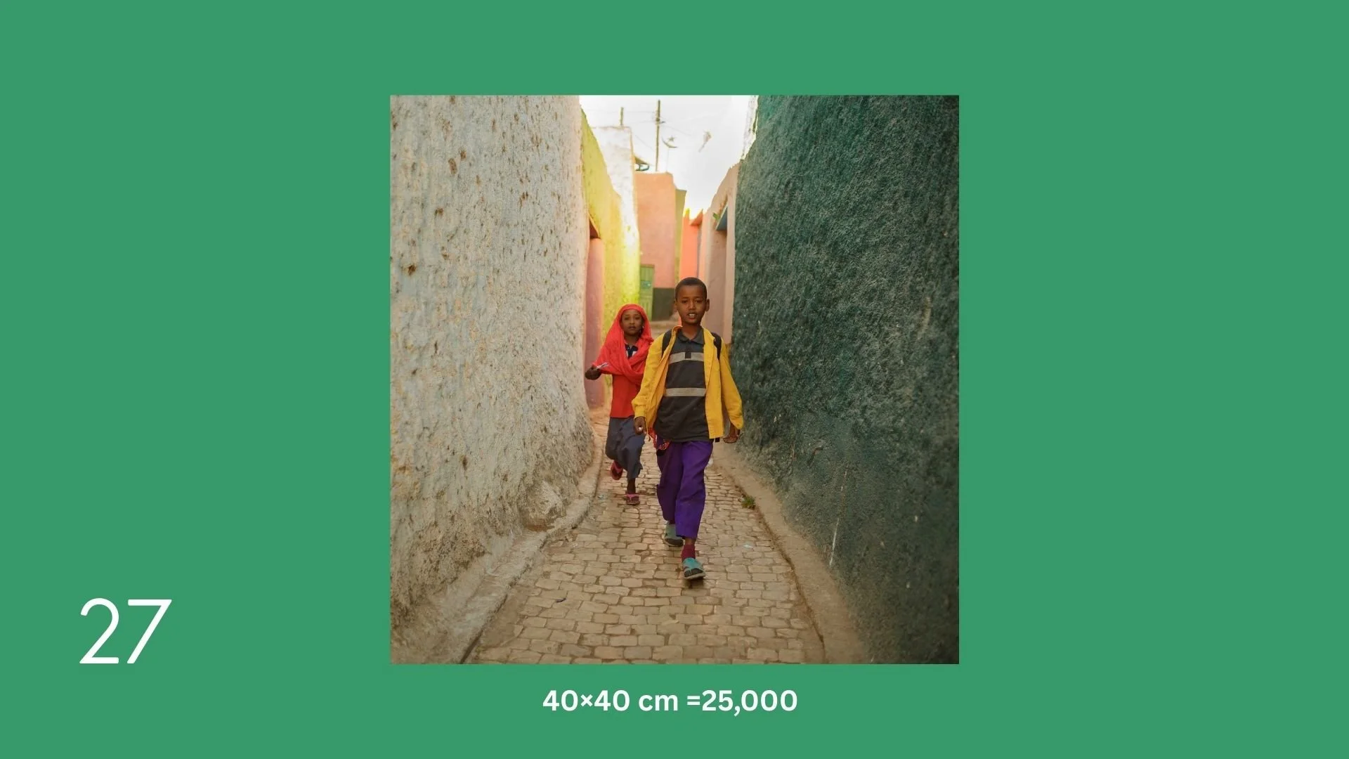 Two children, a boy and a girl, walking through a narrow alleyway with textured walls on either side, one with a lighter color and the other dark green, in a colorful neighborhood.