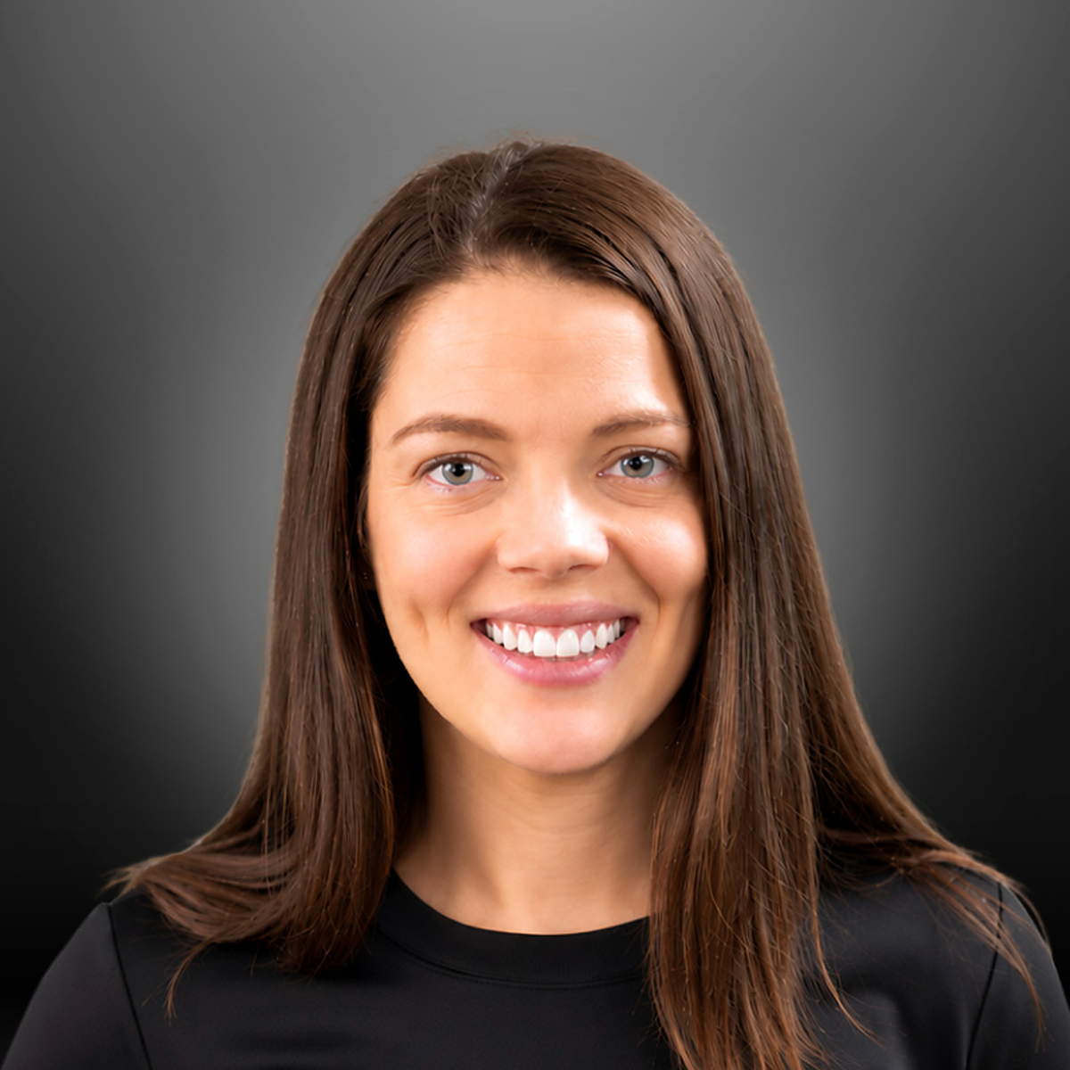 Portrait of a young woman with brown hair, smiling, against a dark gradient background.