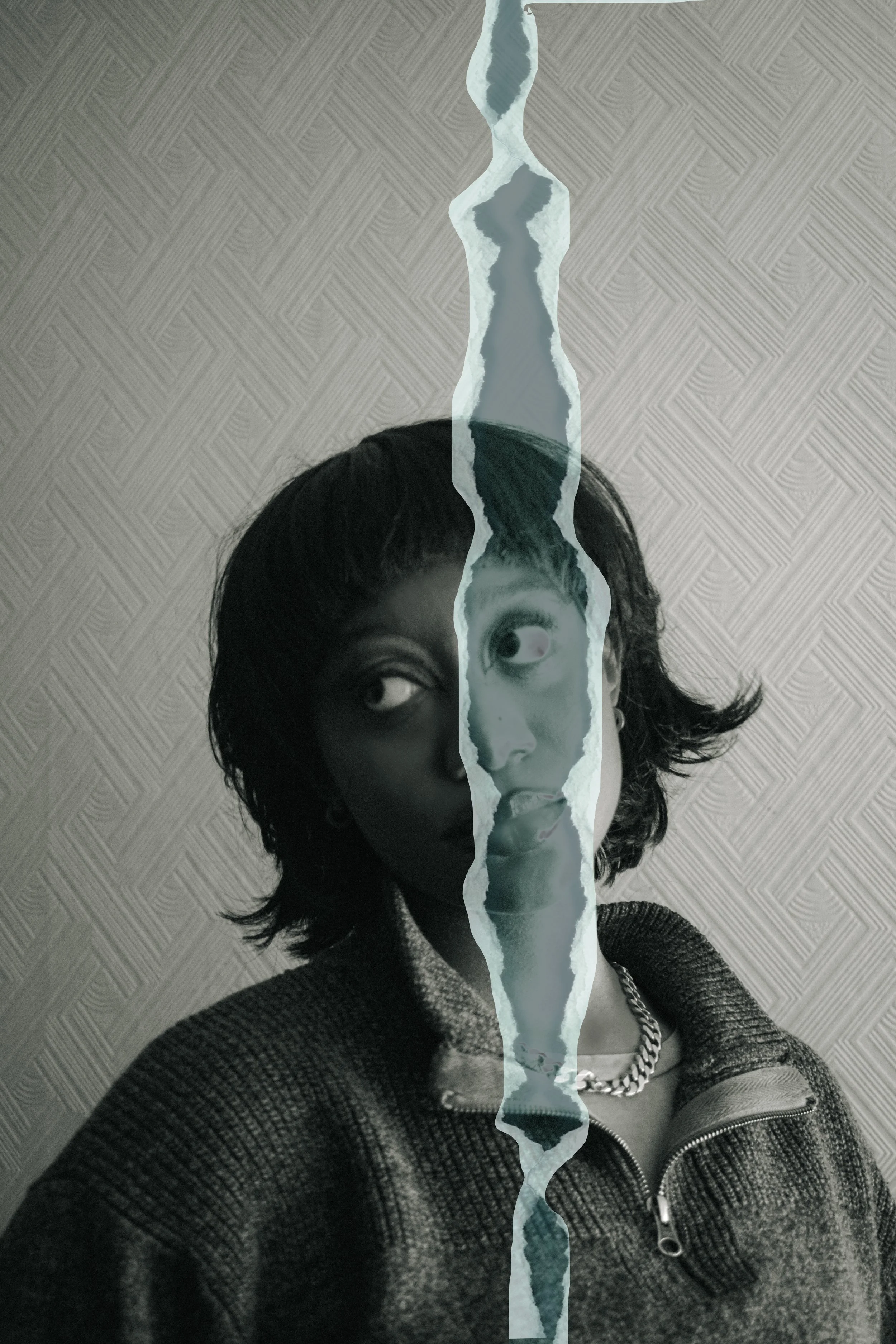 A black and white photo of a woman with short, wavy dark hair, looking to the side. The image is split by a torn paper effect with a watercolor image of water and sky in the center.