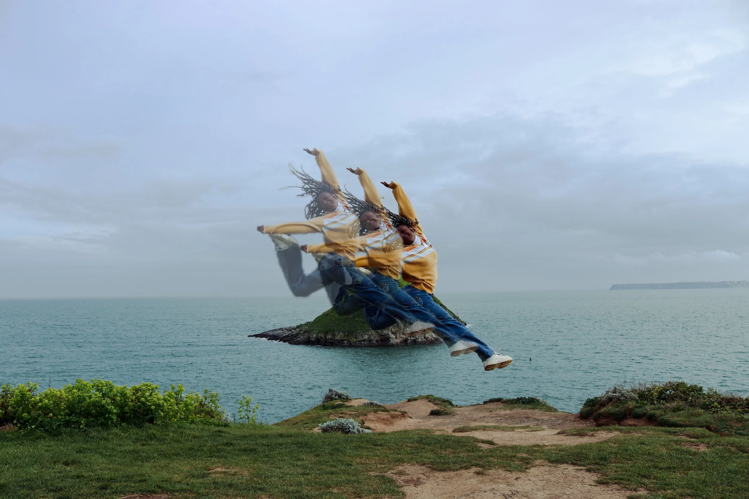 A person with dreadlocks is sitting on a rock near the ocean during daytime, and their image is duplicated with a motion blur effect, creating a sense of movement against a cloudy sky.