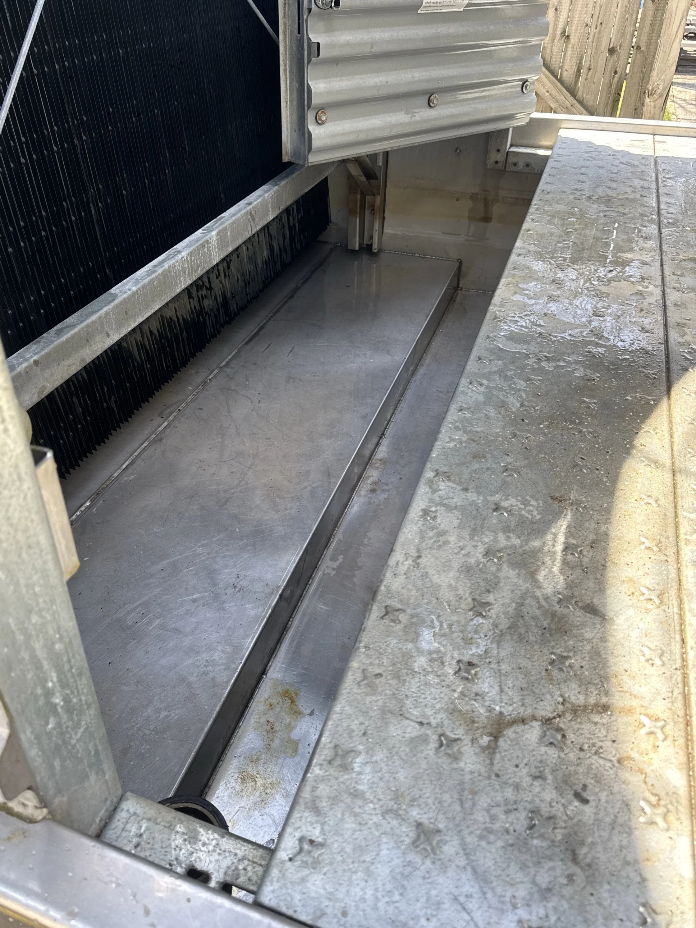 Cooling tower basin with water distribution system