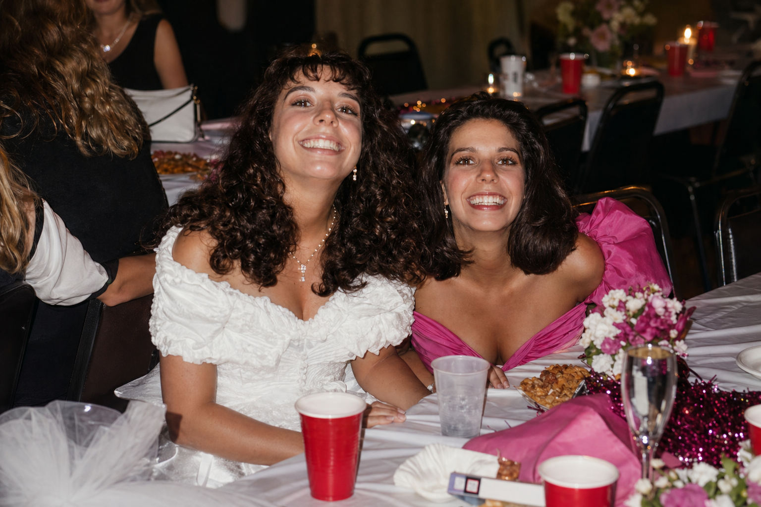 Two smiling young women at a celebration, reflecting family, joy, creativity, and the personal inspiration behind Pineapple Picasso art studio in Cape Coral, Florida.
