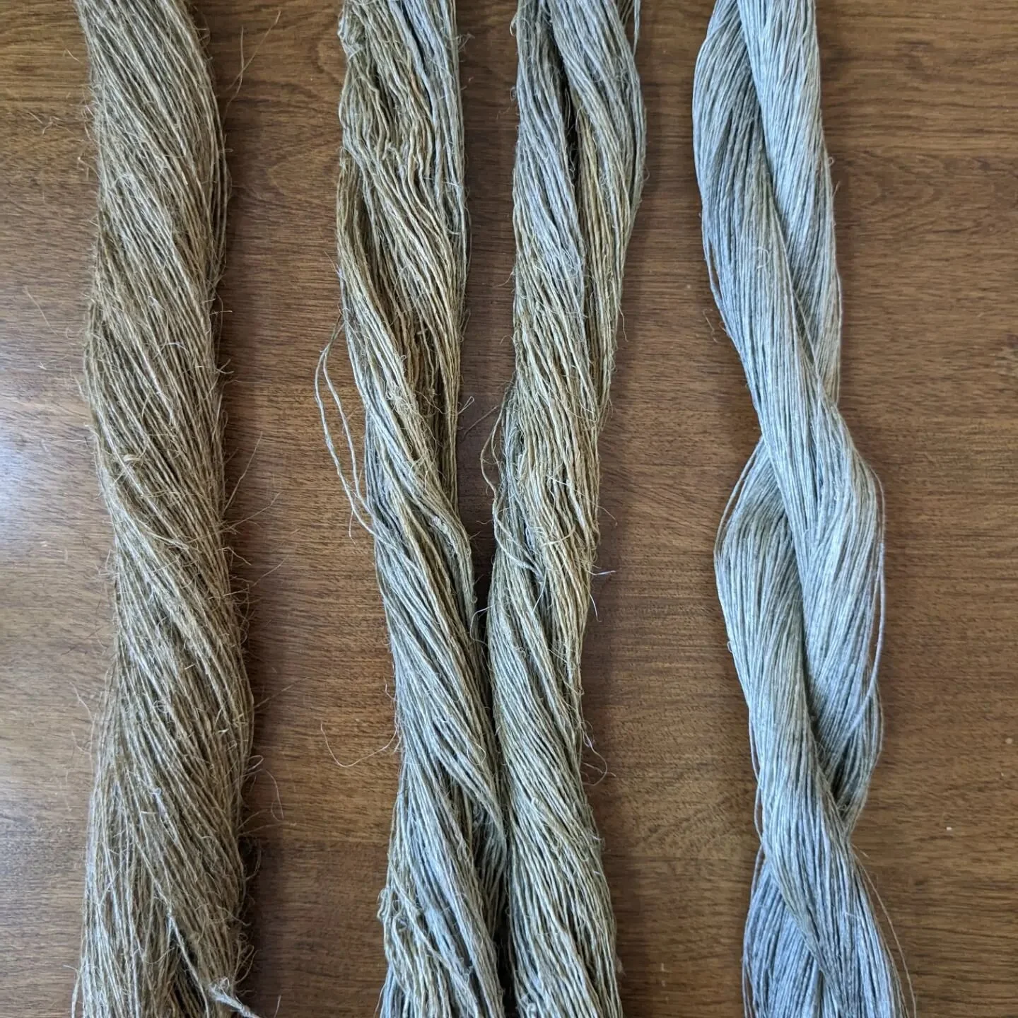 Spinning flax isn't the last step! I'm blown away by the transformations flax goes through over and over on its path to linen cloth. Here are three skeins: one right off the spinning wheel, one that's been scoured by simmering in soda ash and soapy w