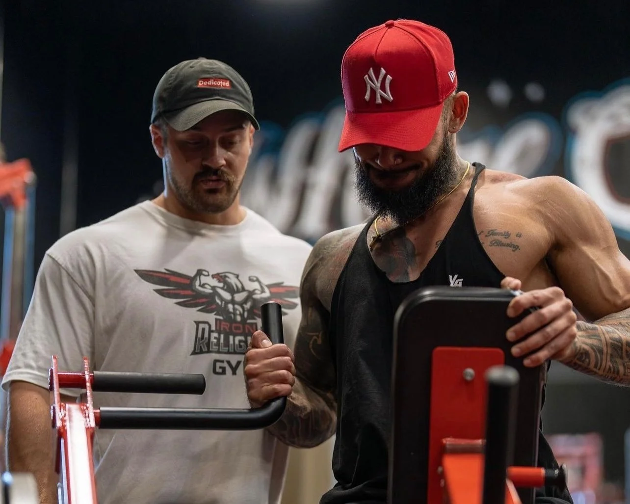 Personal trainer Brett Sanchez-Smith coaching a client through an arm workout at a San Juan Capistrano gym