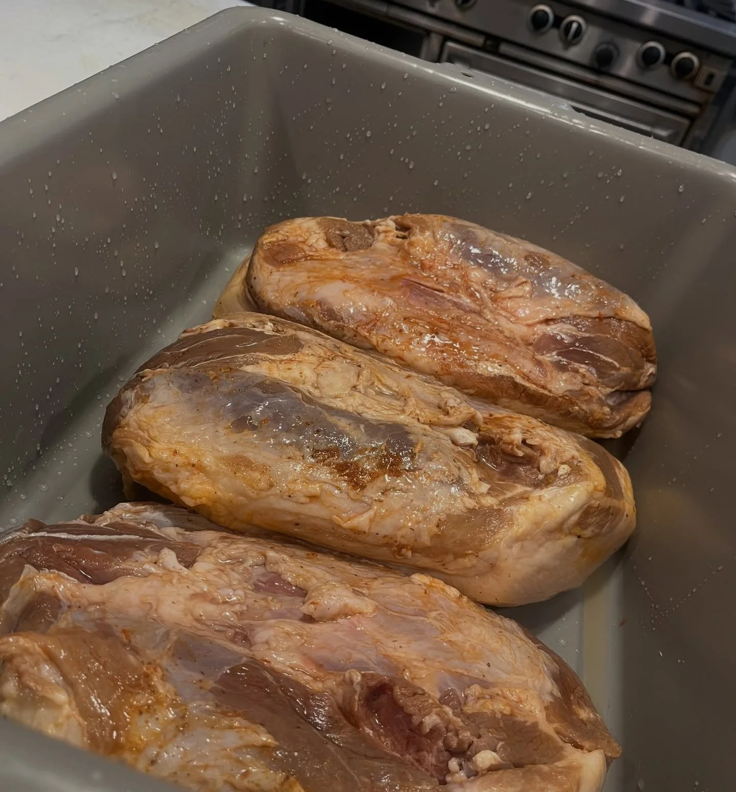 I cured these pork necks with my Dark Side of the Cock  Sauce for a month and they just started hanging.  The Dark Side of the Cock is a red jalape&ntilde;o pepper sauce that has my black lentil miso, black garlic, star anise, black cardamom and long